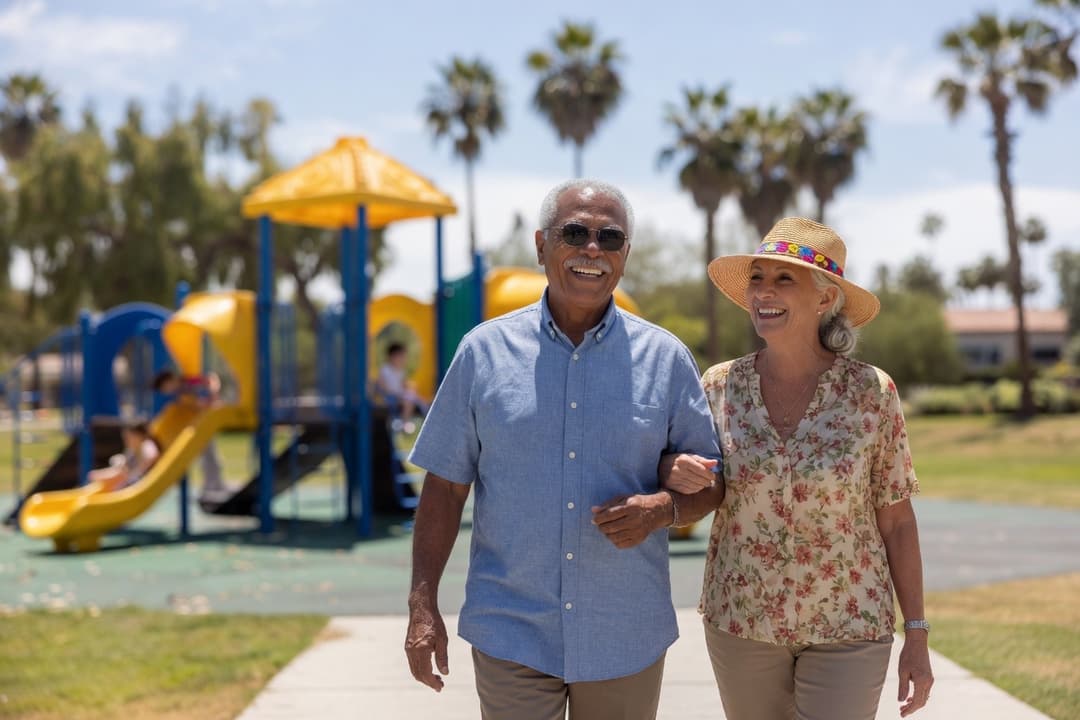 Active senior couple walking together in a Coachella Valley park