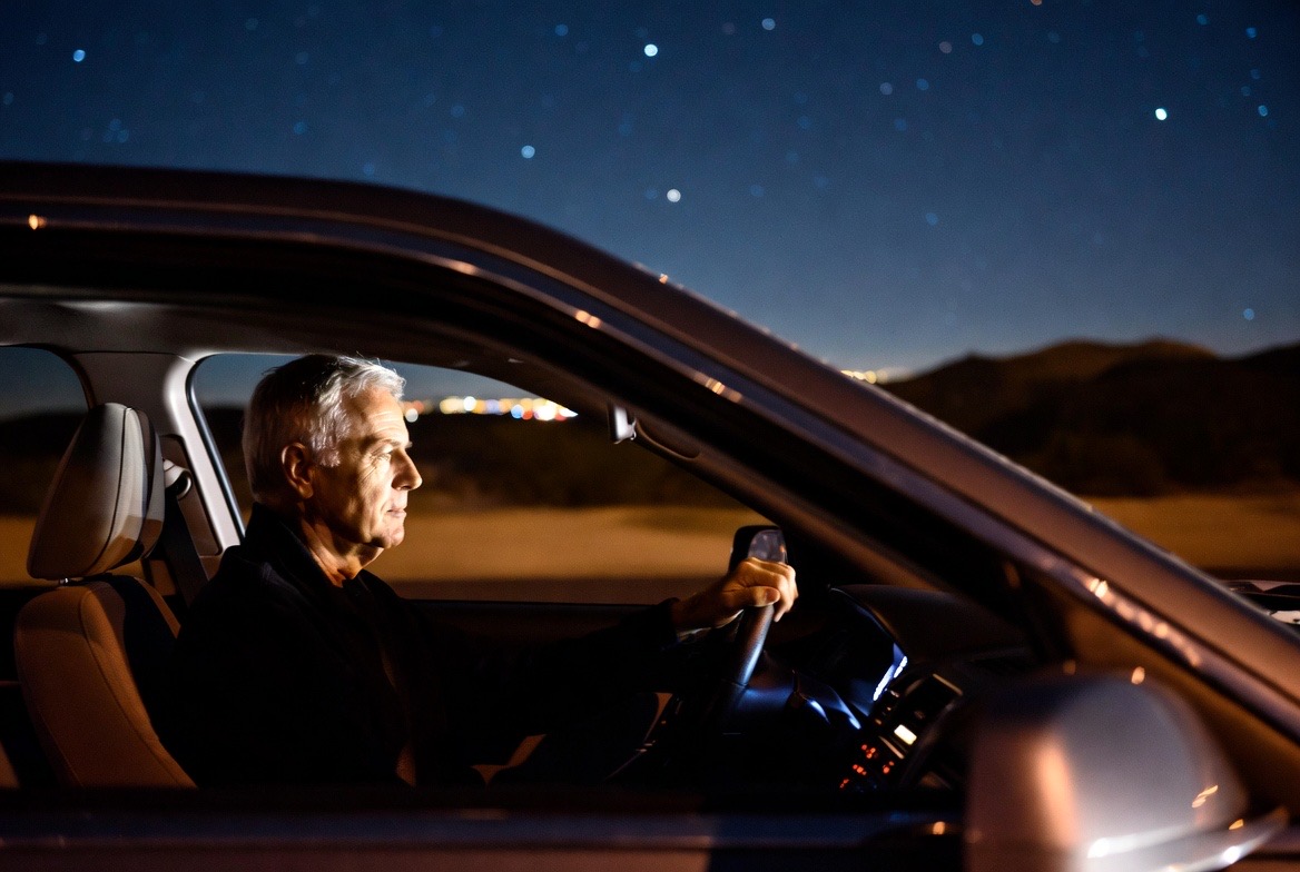 Senior man driving at night with concern about vision clarity